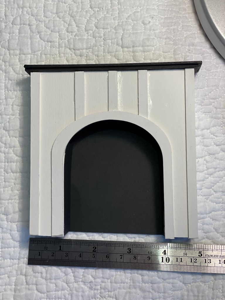 1:12 scale fireplace with arch and trim; white with a black mantel